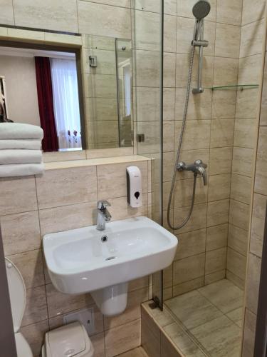 a bathroom with a sink and a shower at Akropol in Gelendzhik