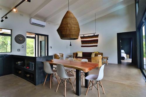 a kitchen and dining room with a wooden table and chairs at Umkhaya in Marloth Park