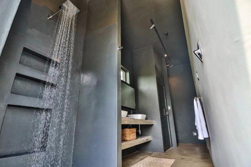 a shower with a glass door in a bathroom at Umkhaya in Marloth Park