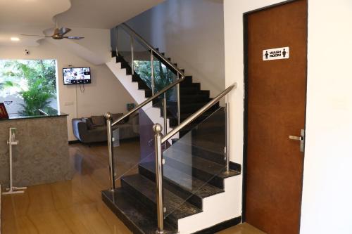 a staircase in a living room with a door at La Vera Boutique Hotel, Mandrem in Mandrem