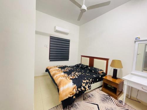 a bedroom with a bed and a window at HOMESTAY PD in Port Dickson