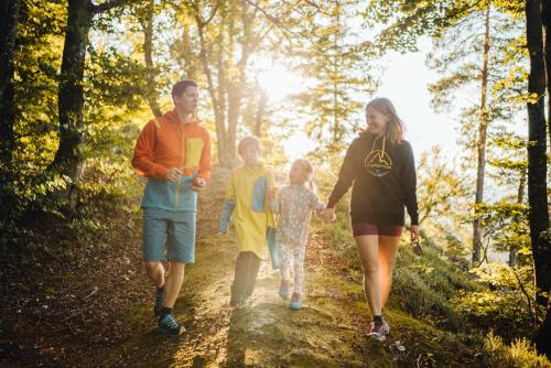 a family walking down a path in the woods at SportApartment Wabnig in Moosburg