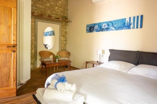 a bedroom with a bed with towels on it at Podere Campriano Winery Adult only in Greve in Chianti