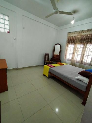 a bedroom with a bed and a mirror in it at Golden Town Hotel in Tangalle