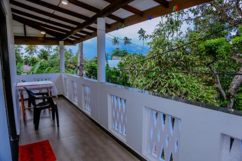 a view from the balcony of a house with a table at Sajana Ocean Hill in Mirissa
