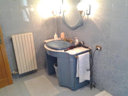 a bathroom with a sink and a mirror at B&BGalatina1 CIS in Galatina