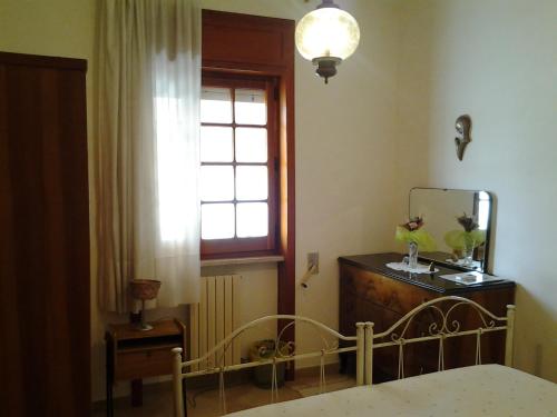 a bedroom with a bed and a mirror and a window at B&BGalatina1 CIS in Galatina