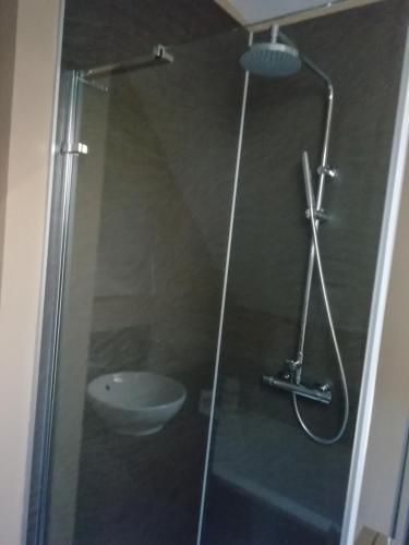 a shower with a glass door with a sink at Carvetii - Halite House - 3 bed House sleeps up to 5 people in Tillicoultry
