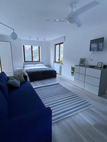 a living room with a couch and a bed at Garda View Apartment in Tenno