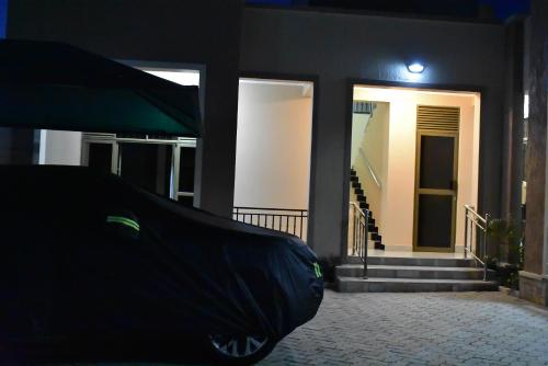 a front view of a house with a ramp in front at Jengel Studio Furnished Apartments in Entebbe
