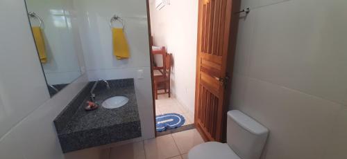 a bathroom with a sink and a toilet at Chácara Primavera in Bonito