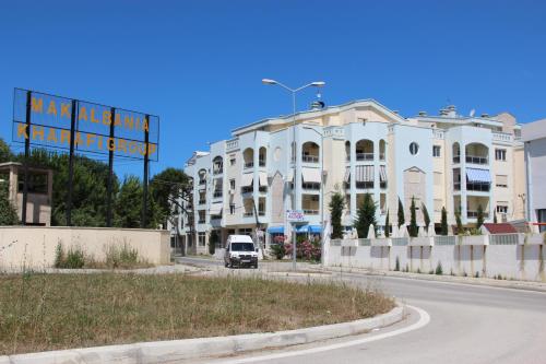 a van driving down a street in front of a building at Golem Apartments in Golem