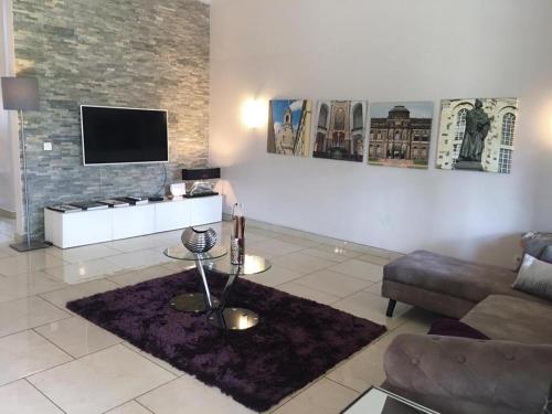 a living room with a couch and a tv at Stunning 3-Bed House in Tema-Ahenfie Villa in Kwedonu