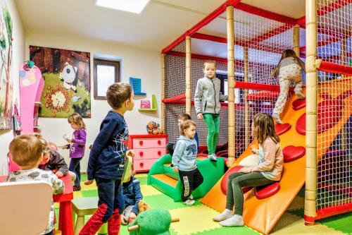 a group of children playing in a play room at Apartmánový Dům Pasťák in Loučná nad Desnou