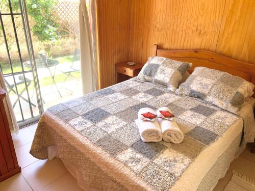 A bed or beds in a room at Hostal Playa Peñuelas