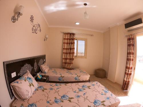 a bedroom with two beds and a window at Safaga house sea view in Hurghada