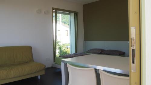 a room with a couch and a table and a bed at INGRAPPA CUBE in Borso del Grappa