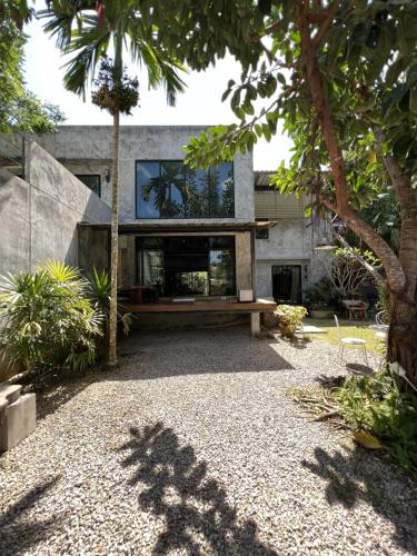 a house with a bench in the middle of a courtyard at Aonang Third Place Hometel in Ao Nang Beach