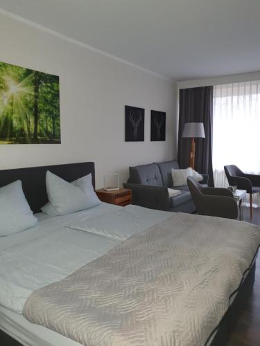 a bedroom with a bed and a living room at Apartment am Bocksberg in Hahnenklee-Bockswiese