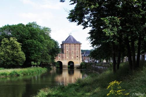 a building with a bridge over a river at Gîte des trois vallees in Nouzonville