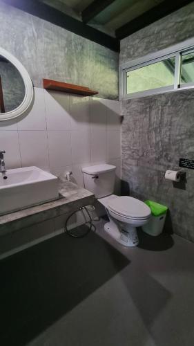 a bathroom with a white toilet and a sink at Aonang Third Place Hometel in Ao Nang Beach