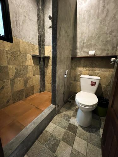a bathroom with a toilet and a shower at Aonang Third Place Hometel in Ao Nang Beach
