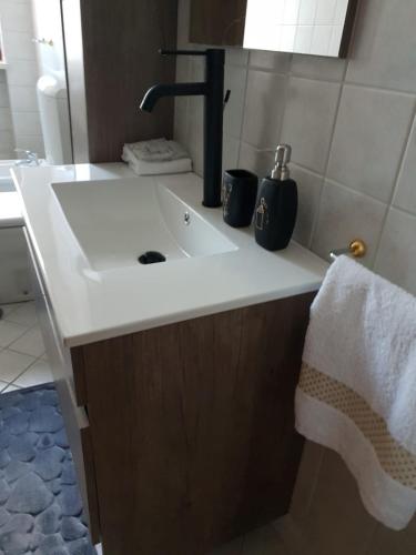 a bathroom sink with a black faucet and a towel at Appartamento Ottoboni,Centro Storico in Pordenone