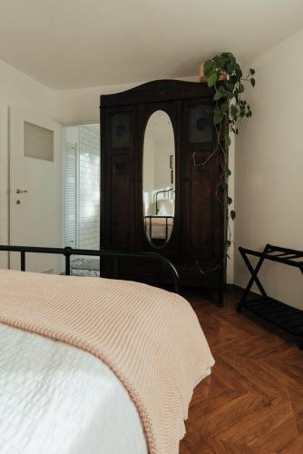 a bedroom with a wooden dresser with a mirror at Authentieke vakantiewoning op 200 m van het strand in De Panne