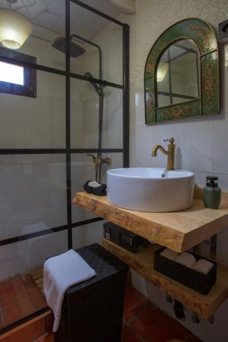 a bathroom with a white sink and a shower at Madeira Black Sand House by Stay Madeira Island in Seixal