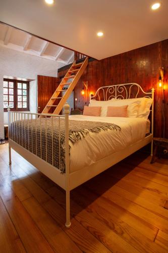 a bedroom with a bed with a wooden wall at Madeira Black Sand House by Stay Madeira Island in Seixal