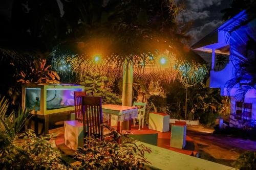 a room with a table and chairs and a tv at Sajana Ocean Hill in Mirissa