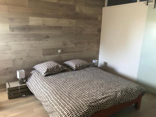 a bedroom with a bed with two pillows on it at Les Gîtes "Le Petit Val" in Durbuy
