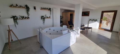a white bath tub sitting in a room at Chalet Sophie - Luxury Chalet in Roletto