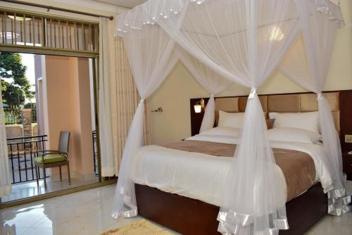 a bedroom with a bed with mosquito netting at Studio - Sleeps 2 - Free Airport Pickup in Entebbe