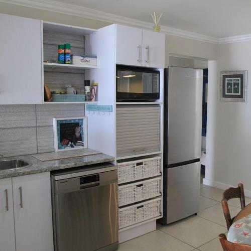 a kitchen with a refrigerator and a microwave at Allalapstix in Reebok