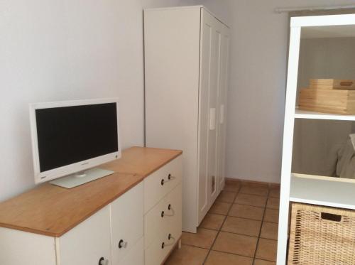 a computer monitor on a dresser in a room at Apartamento Centrico con Terraza in Platja  d'Aro