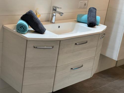 a bathroom sink with two towels on top of it at Apart Kathrin in Fliess