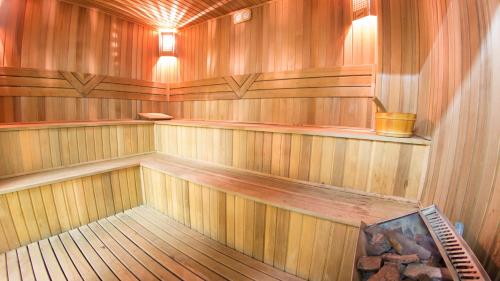 an empty sauna with wooden walls and wooden floors at Arena Hotel Kur in Mingachevir
