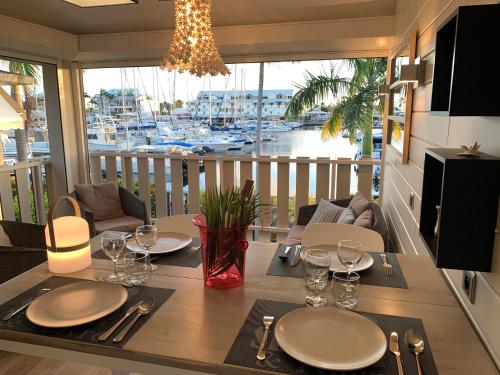 a dining room table with a view of a marina at Marina MANZANA, Appartement neuf, vue mer exceptionnelle - LUXE in Saint-François
