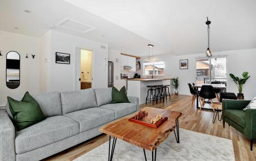 a living room with a couch and a table at 100 Chemin des Ruisselets in Stoneham