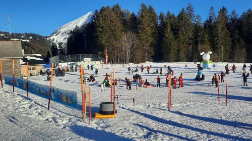 a group of people on a ski slope in the snow at Large Apartment 8beds great for family and friends, Mountain View in Amden