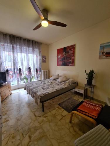 a bedroom with a bed and a ceiling fan at Casa dell amore 1 in Sanremo