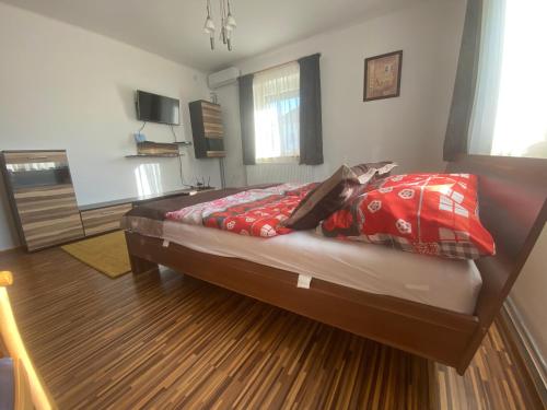 A bed or beds in a room at Bella apartman