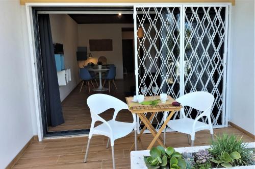 a patio with a table and chairs on a balcony at Vilamoura Garden House - Golf & Beach in Vilamoura