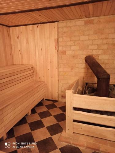 a corner of a sauna with a bench and a fireplace at Сімейний Затишок апартаменти in Oryavchyk