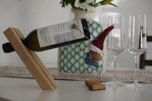 a bottle of wine on a table next to two glasses at Il Riccio del Castagno in Novaledo