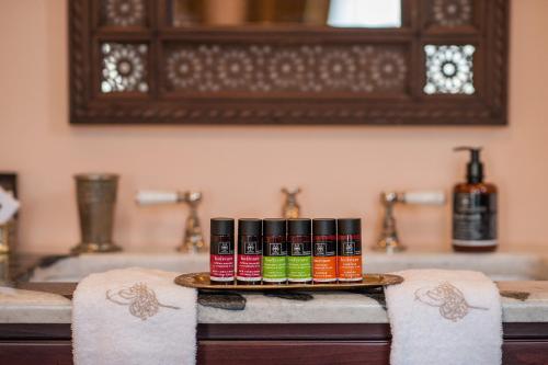 a tray with four bottles of essential oils on a bathroom counter at La Maison Ottomane in Chania Town