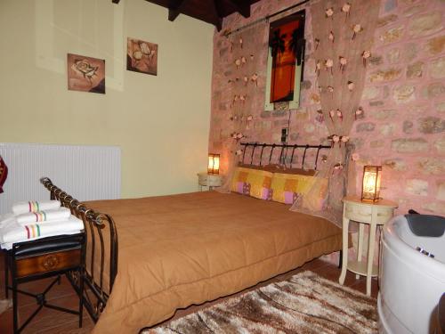 a bedroom with a bed and a stone wall at Junior Suite Selini for 2 people in Vitina