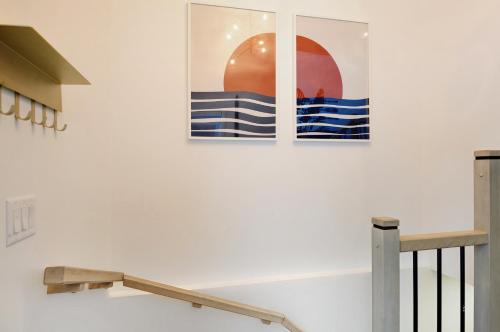 two pictures on a wall next to a staircase at 13 Chemin des Cascades in Stoneham