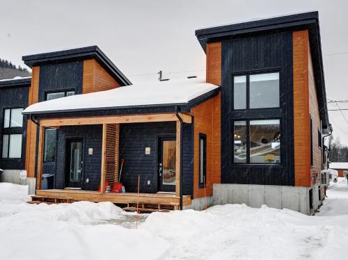 a house is being built in the snow at 13 Chemin des Cascades in Stoneham